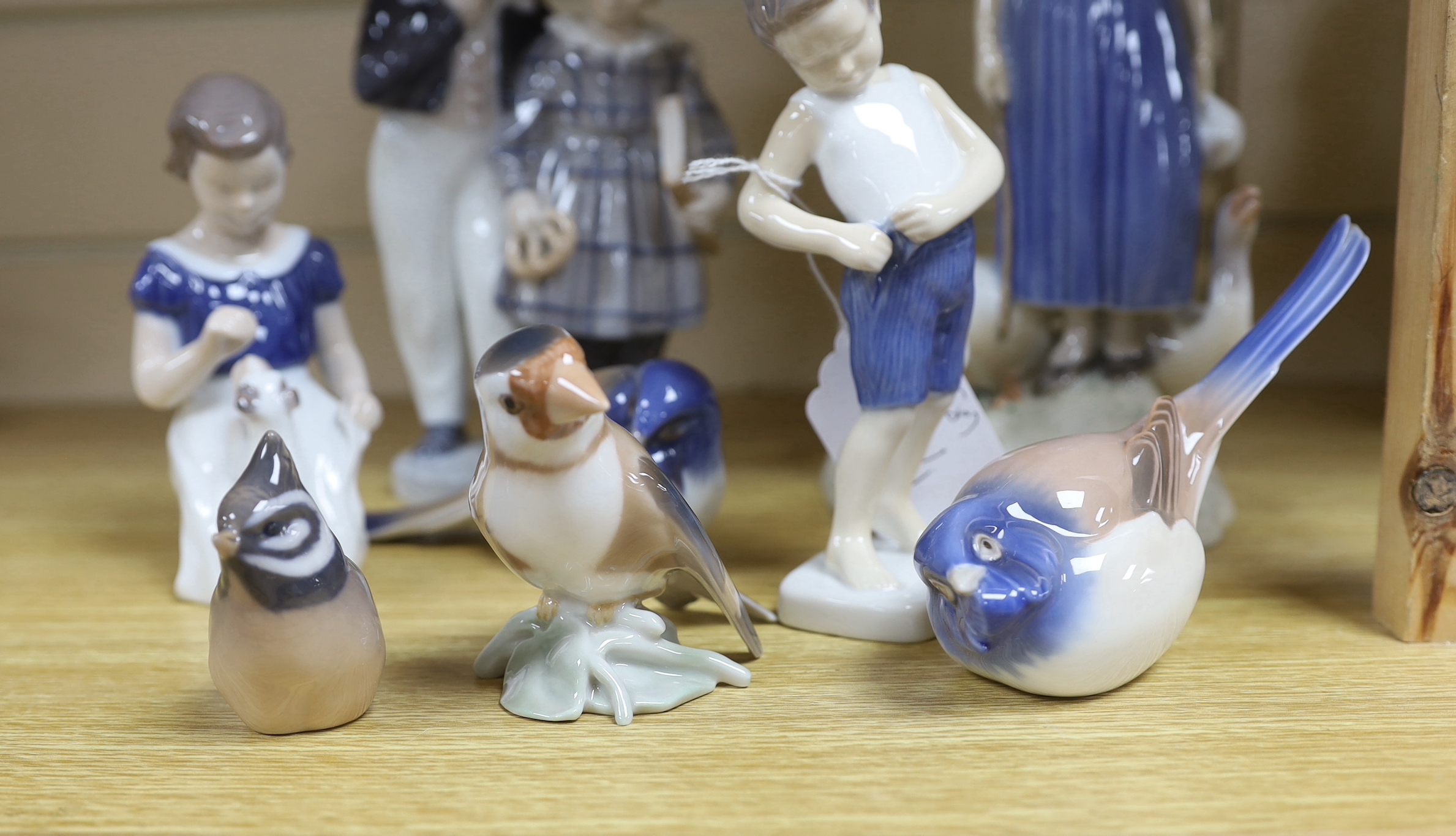 Eight items of mixed Royal Copenhagen and Bing & Grondahl, including figure groups birds and children, tallest 24cms high